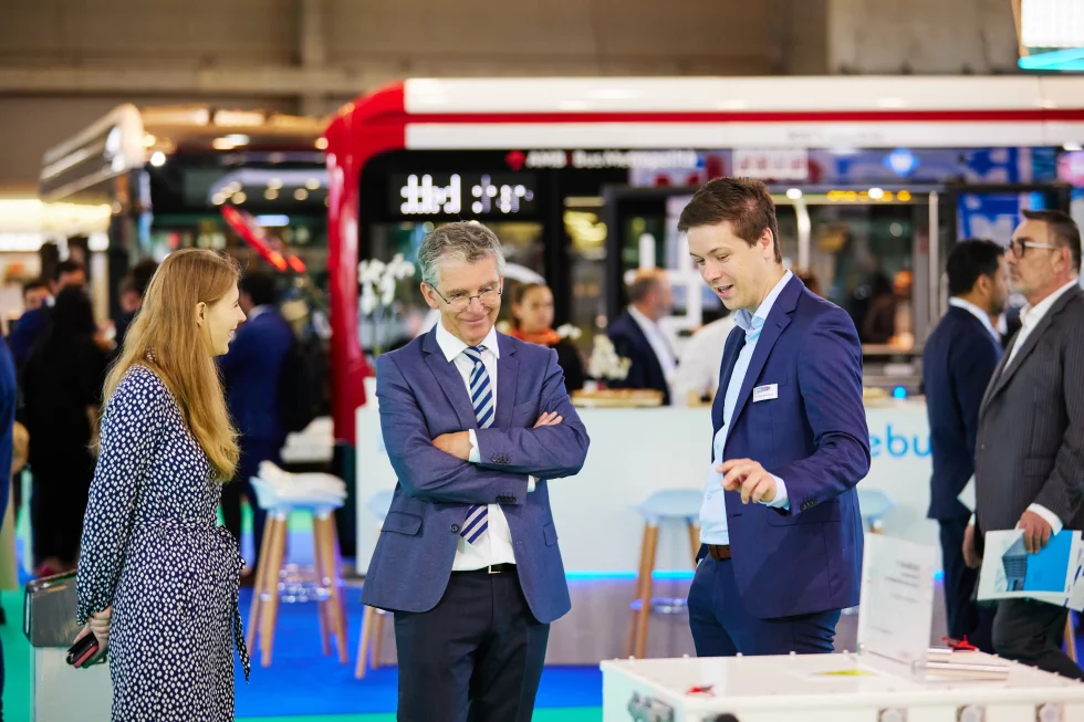 Three people discussing at the UITP Summit