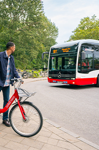 man on a bike and a bus approaching